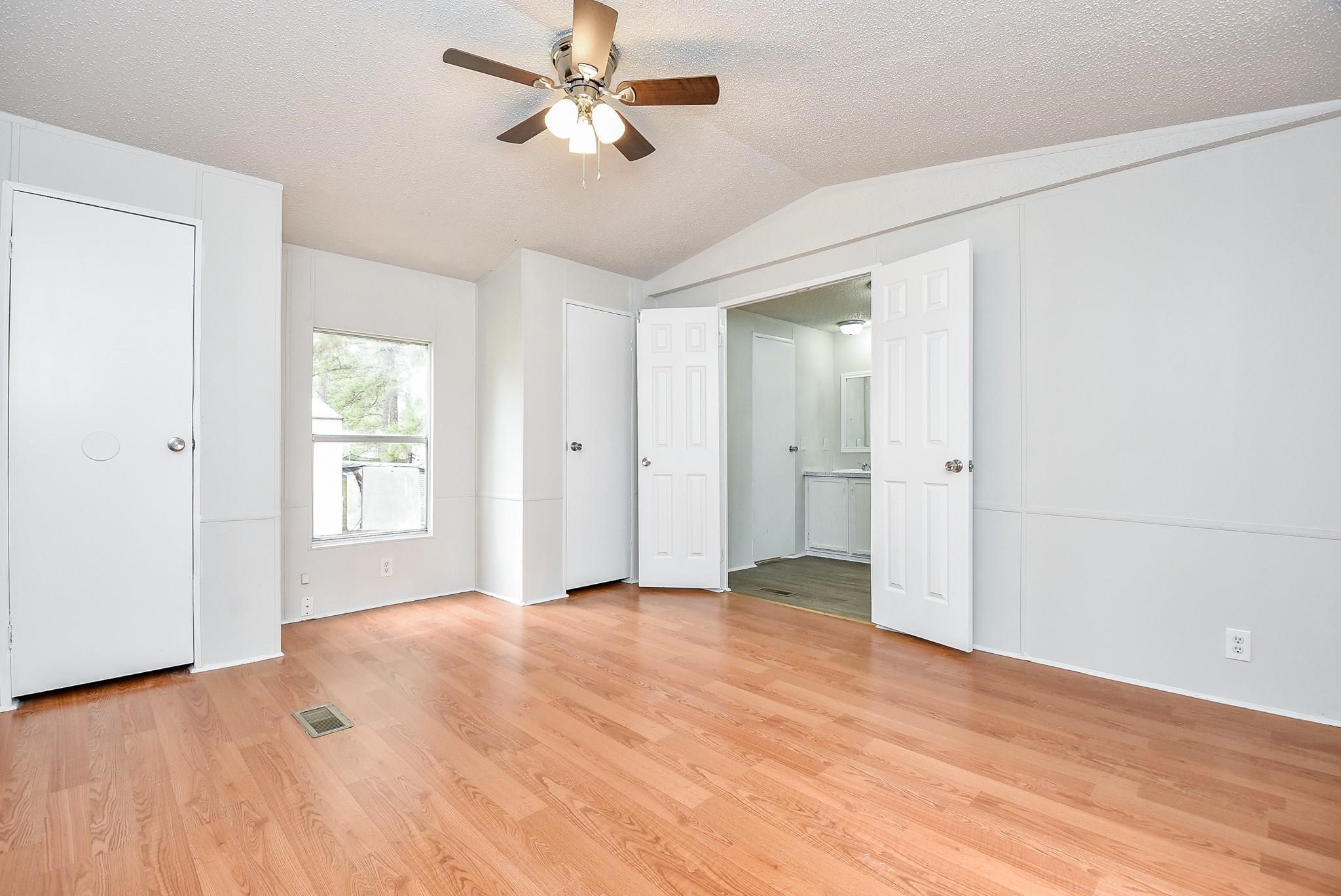 12842 Roy Harris Loop Conroe, TX 77306 - Photo 29 of 36 a view of empty room with wooden floor and fan