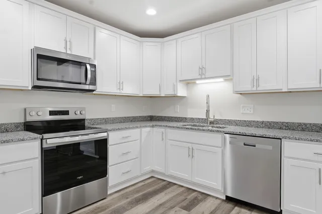 a bathroom with a granite countertop sink and vanity