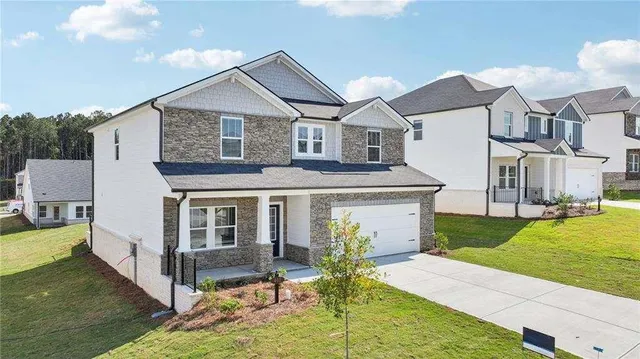 a aerial view of a house with swimming pool and a yard