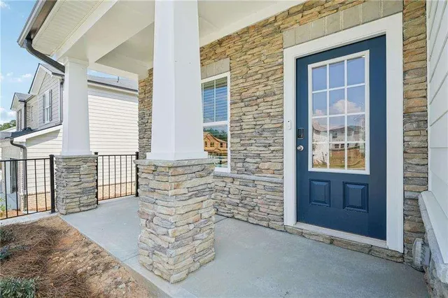 a view of front door of house with stairs