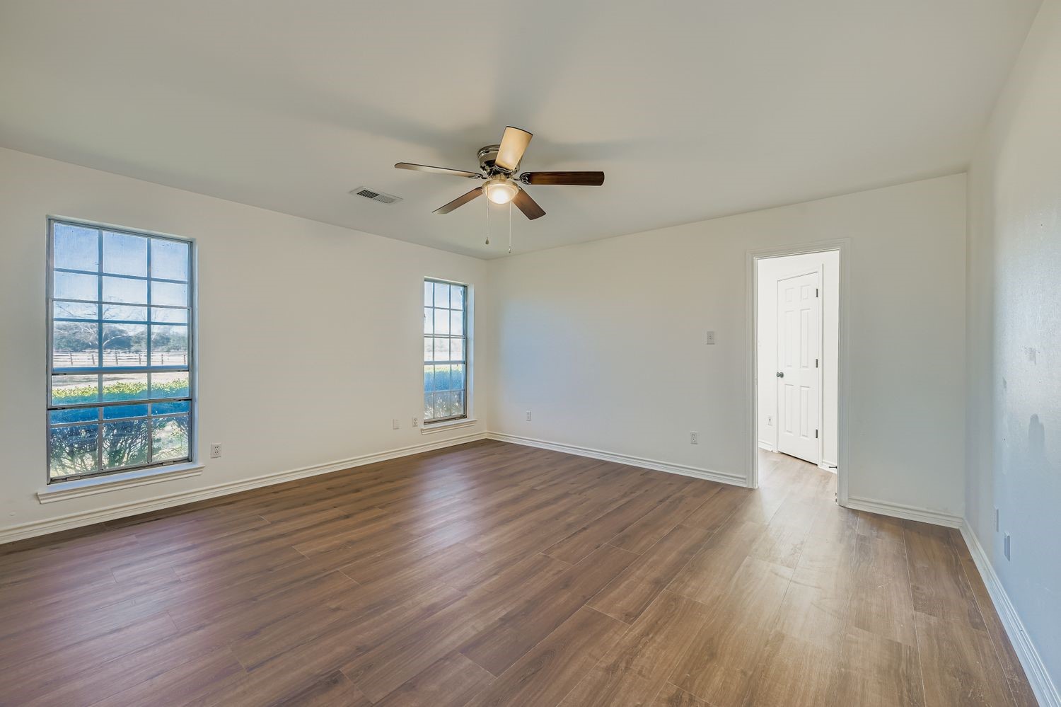 34411 Fulshear Farms Road Fulshear, TX 77441 - Photo 15 of 29 a view of an empty room with a window and wooden floor
