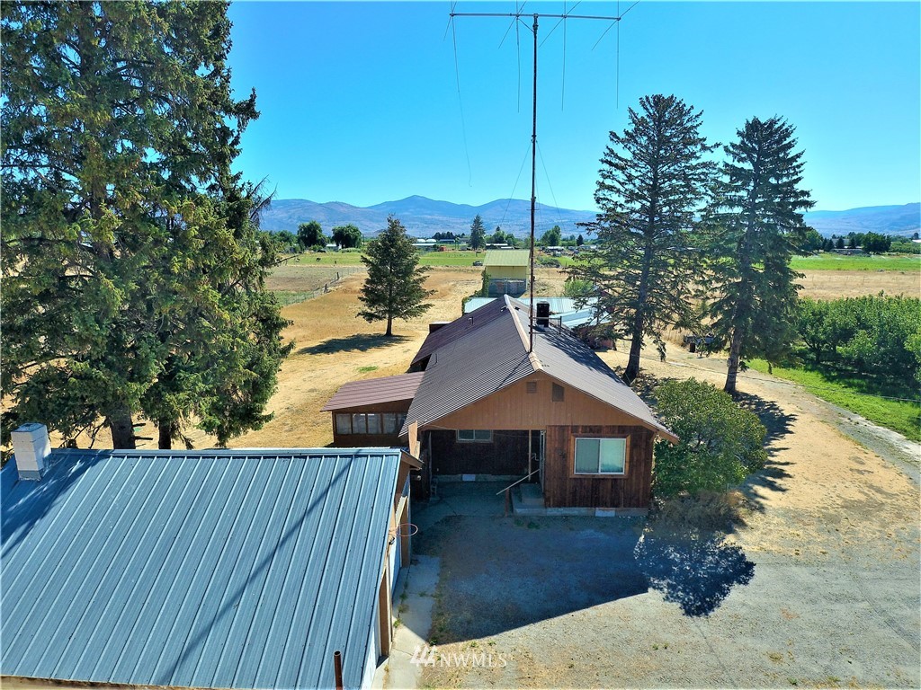 a front view of a house with a yard and lake view