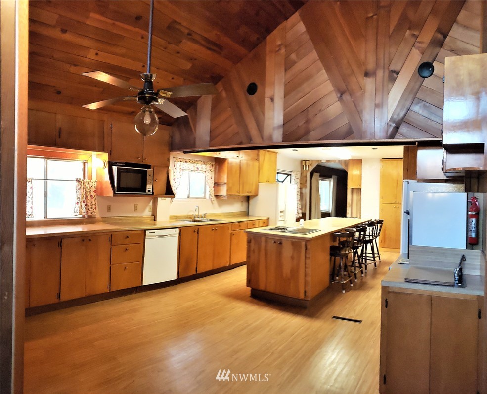 62 North Kirkpatrick Road North Omak, WA 98841 - Photo 14 of 33 a kitchen with stainless steel appliances kitchen island granite countertop a stove a sink and a microwave