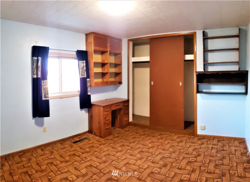 62 North Kirkpatrick Road North Omak, WA 98841 - Photo 18 of 33 a bedroom with a bed and a refrigerator