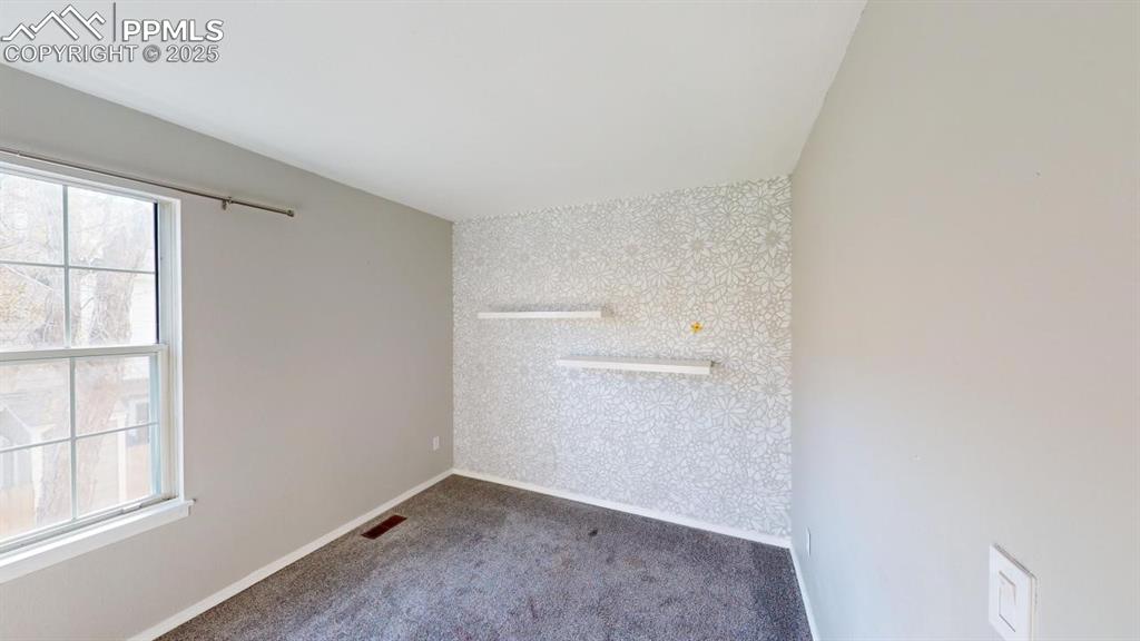 1811 South Quebec Way, Unit 194 Denver, CO 80231 - Photo 8 of 10 an empty room with windows and closet