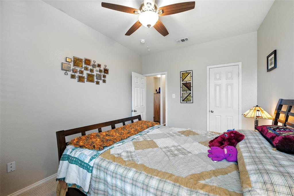 5817 Deck House Road Fort Worth, TX 76179 - Photo 12 of 28 a bedroom with a bed and a chandelier