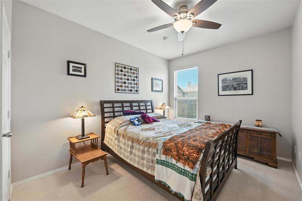 5817 Deck House Road Fort Worth, TX 76179 - Photo 13 of 28 a bedroom with a bed and a chandelier