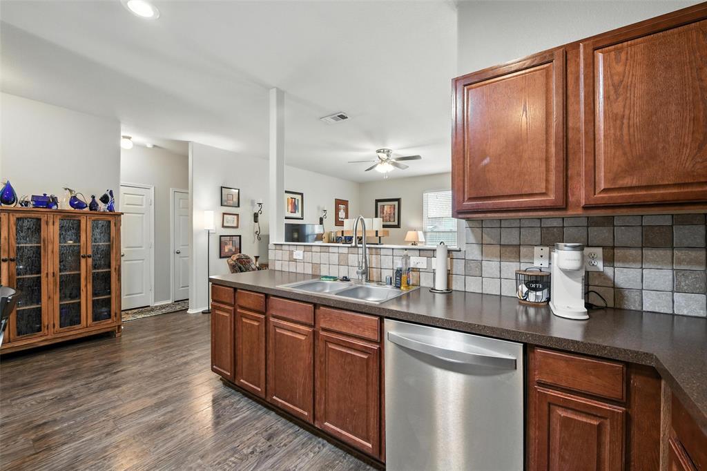 5817 Deck House Road Fort Worth, TX 76179 - Photo 15 of 28 a kitchen with stainless steel appliances granite countertop a sink stove and cabinets