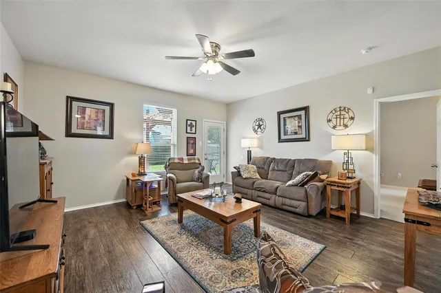 a living room with furniture a chandelier and a window