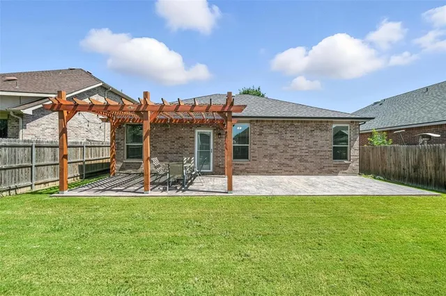 a view of a house with a yard and sitting area
