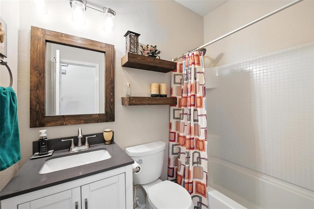 5817 Deck House Road Fort Worth, TX 76179 - Photo 10 of 28 a bathroom with a sink a toilet and shower