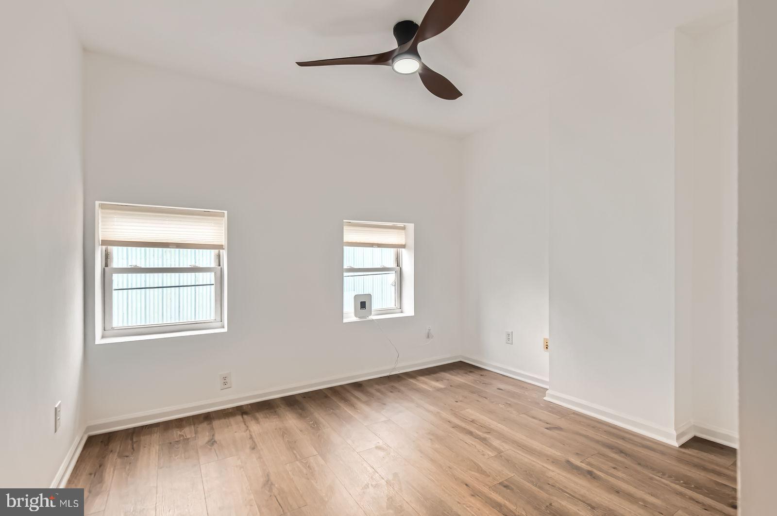 1440 Ward Street Baltimore, MD 21230 - Photo 12 of 27 an empty room with wooden floor cabinet and windows