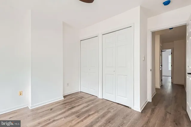 a view of hallway with wooden floor