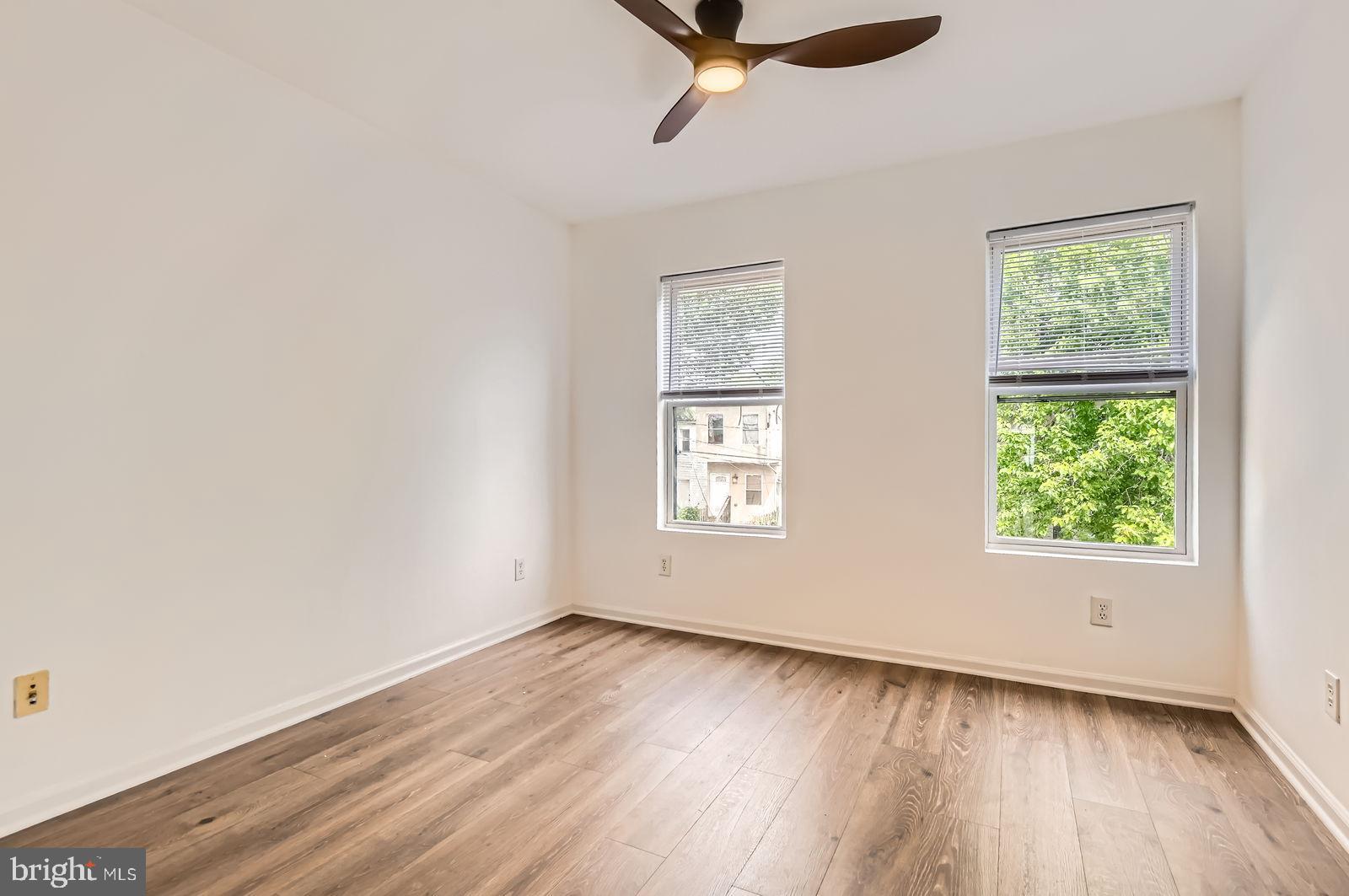 1440 Ward Street Baltimore, MD 21230 - Photo 17 of 27 an empty room with wooden floor and windows