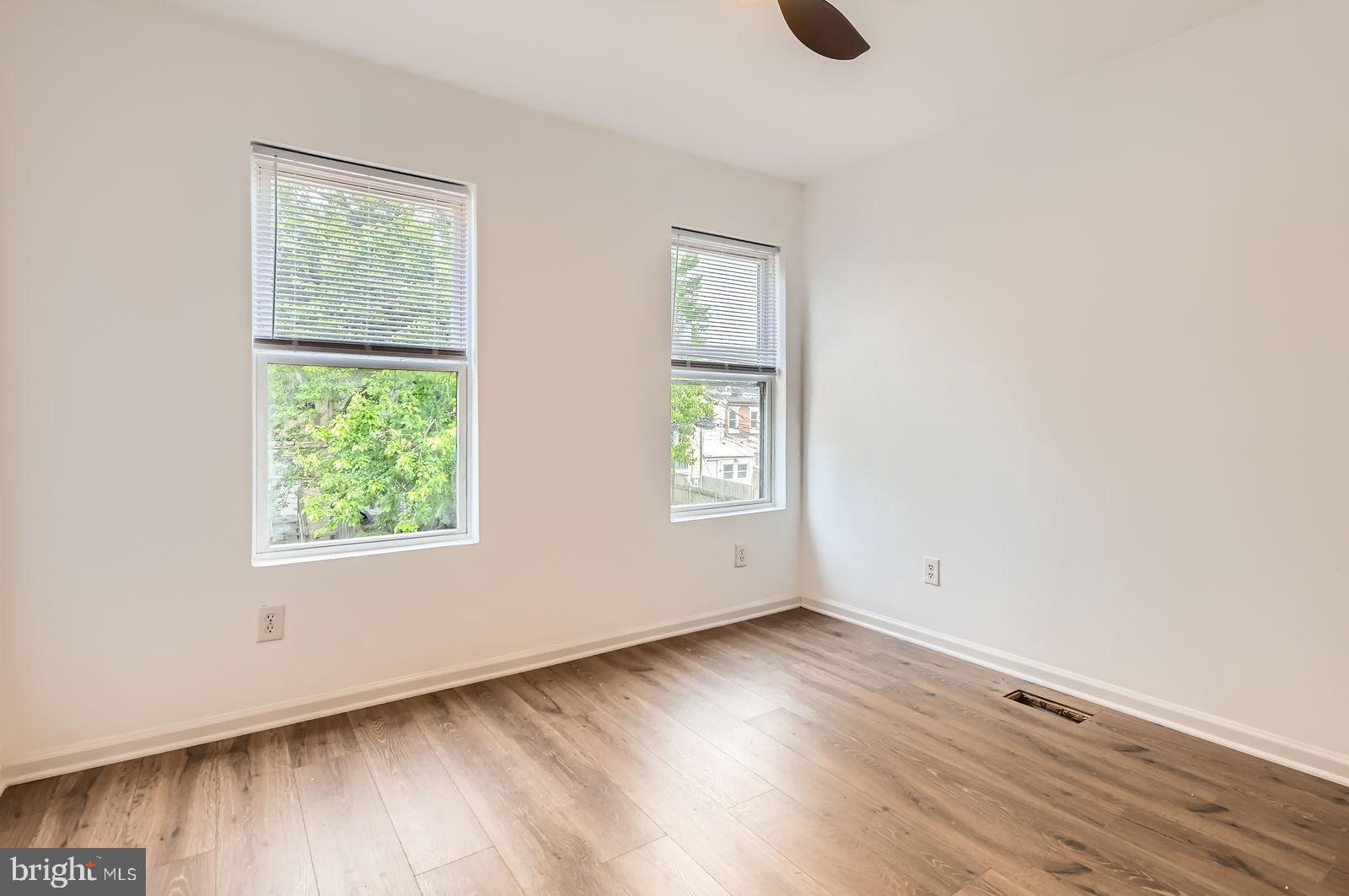 1440 Ward Street Baltimore, MD 21230 - Photo 19 of 27 an empty room with wooden floor and windows