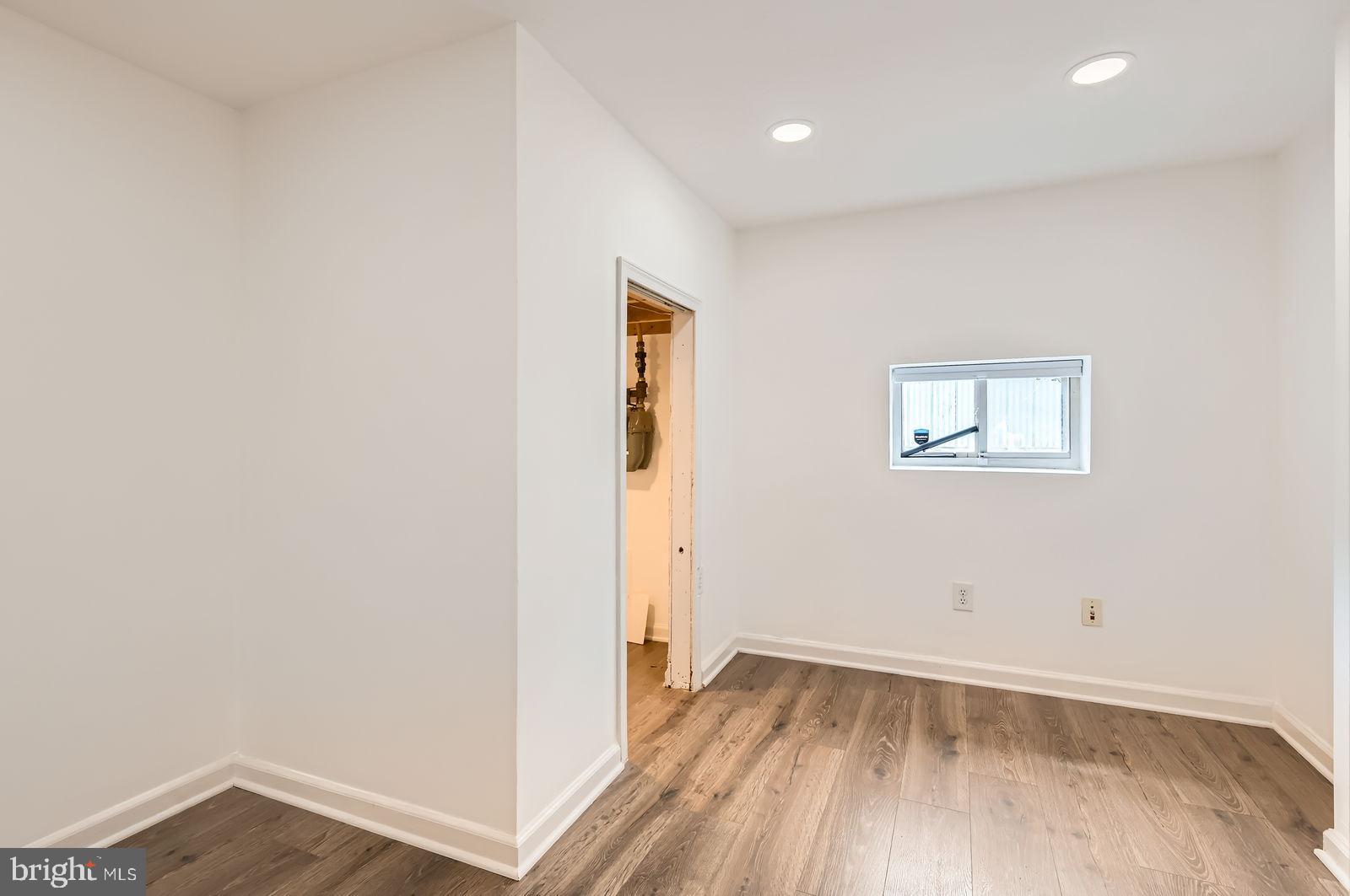1440 Ward Street Baltimore, MD 21230 - Photo 21 of 27 an empty room with wooden floor and windows
