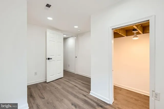 a view of hallway with wooden floor