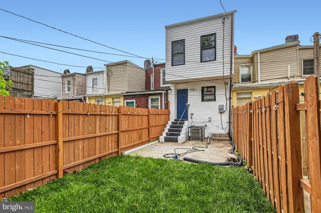 a backyard of a house with yard and outdoor seating