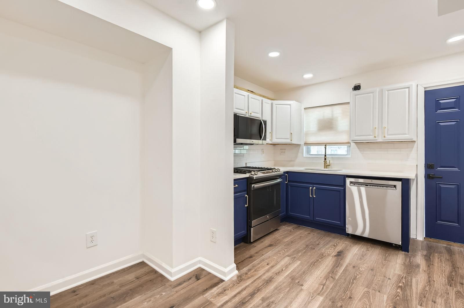 1440 Ward Street Baltimore, MD 21230 - Photo 8 of 27 a kitchen with granite countertop a refrigerator and a stove top oven