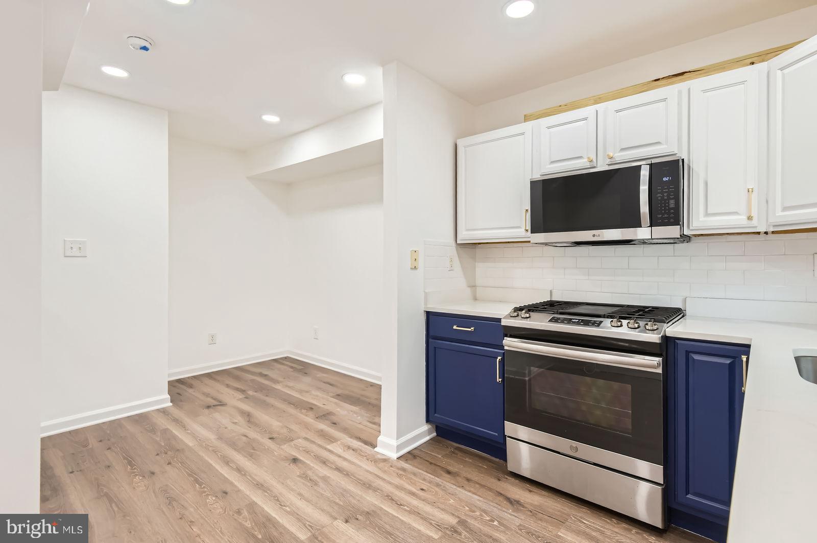 1440 Ward Street Baltimore, MD 21230 - Photo 9 of 27 a kitchen with granite countertop cabinets stainless steel appliances and wooden floor