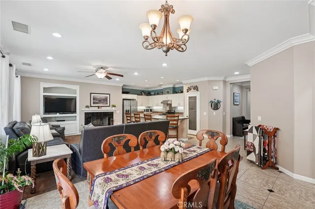 a very nice looking dining room with furniture wooden floor and a chandelier