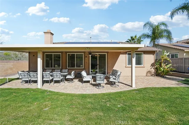 a view of a house with backyard sitting area and garden