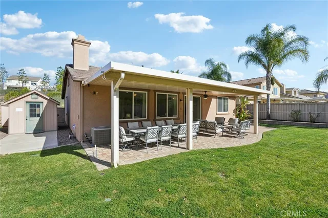 a view of a house with backyard porch and sitting area