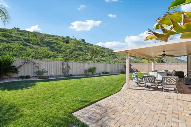 a view of a patio with a table and chairs