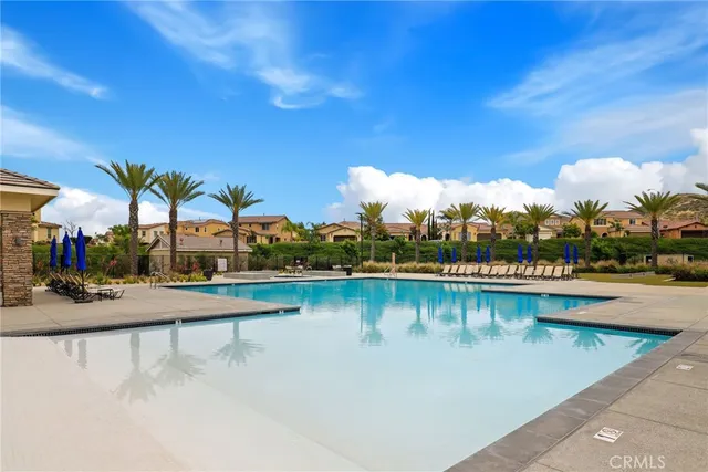 a view of a swimming pool with outdoor seating
