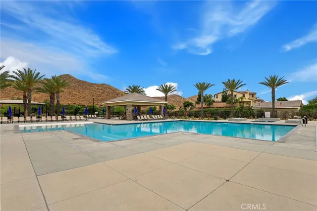 a view of swimming pool with outdoor seating and a garden