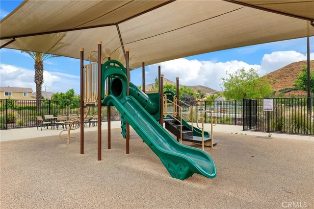 a view of a patio with a table and chairs under an umbrella