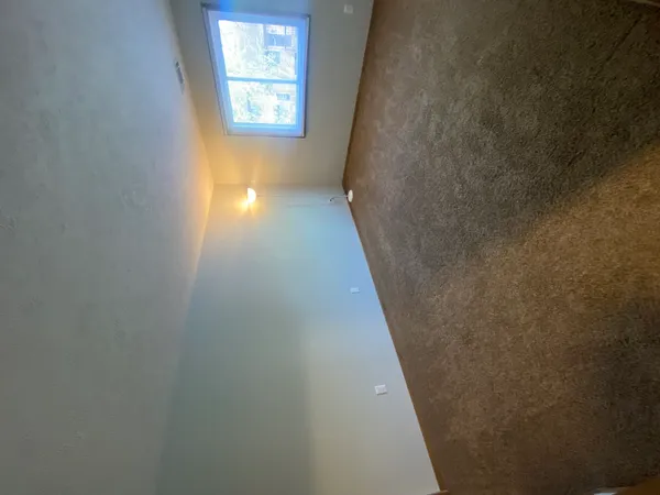 a view of an empty room and window