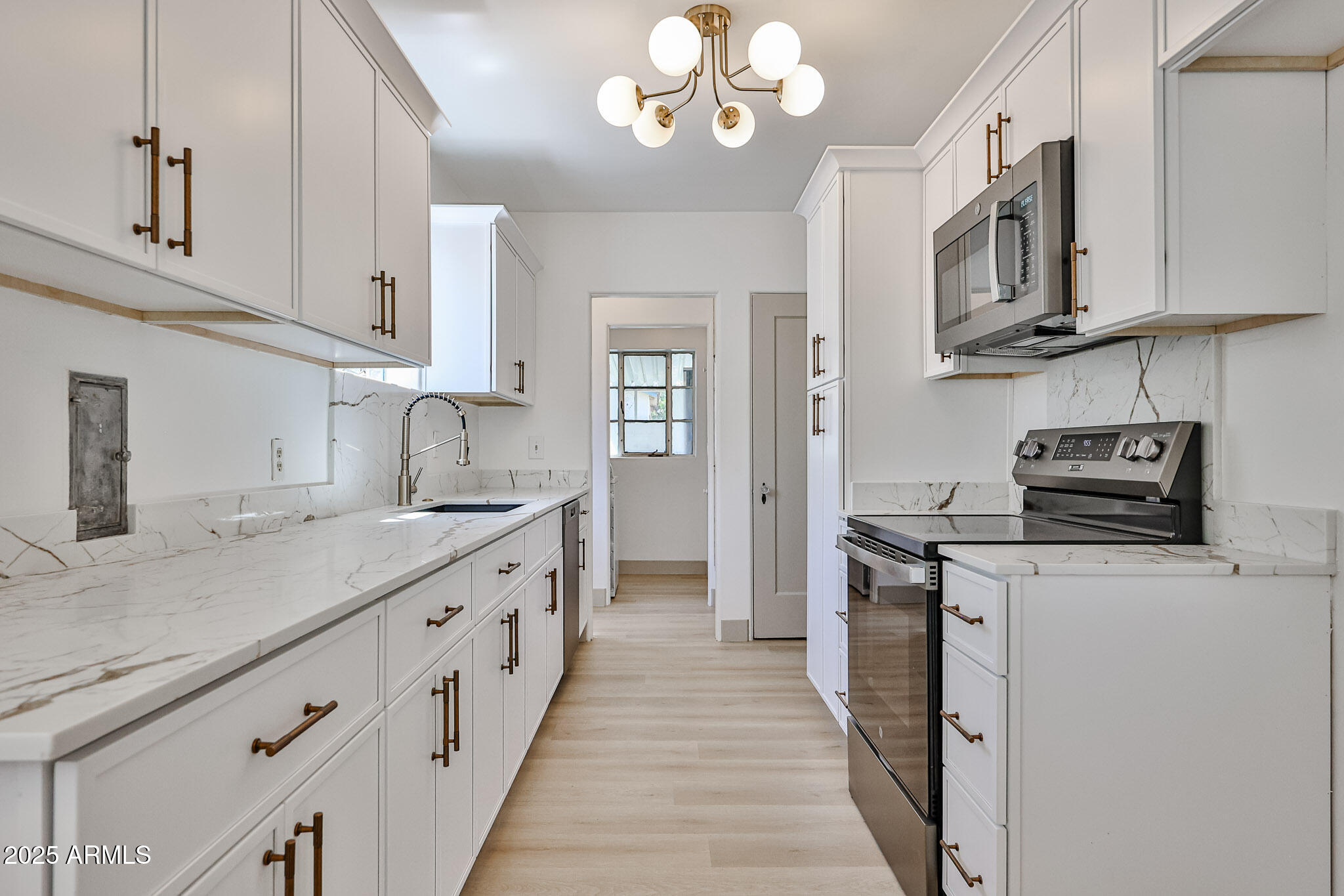63 West Windsor Avenue Phoenix, AZ 85003 - Photo 14 of 43 a kitchen with stainless steel appliances granite countertop a sink and dishwasher a stove top oven with wooden floor
