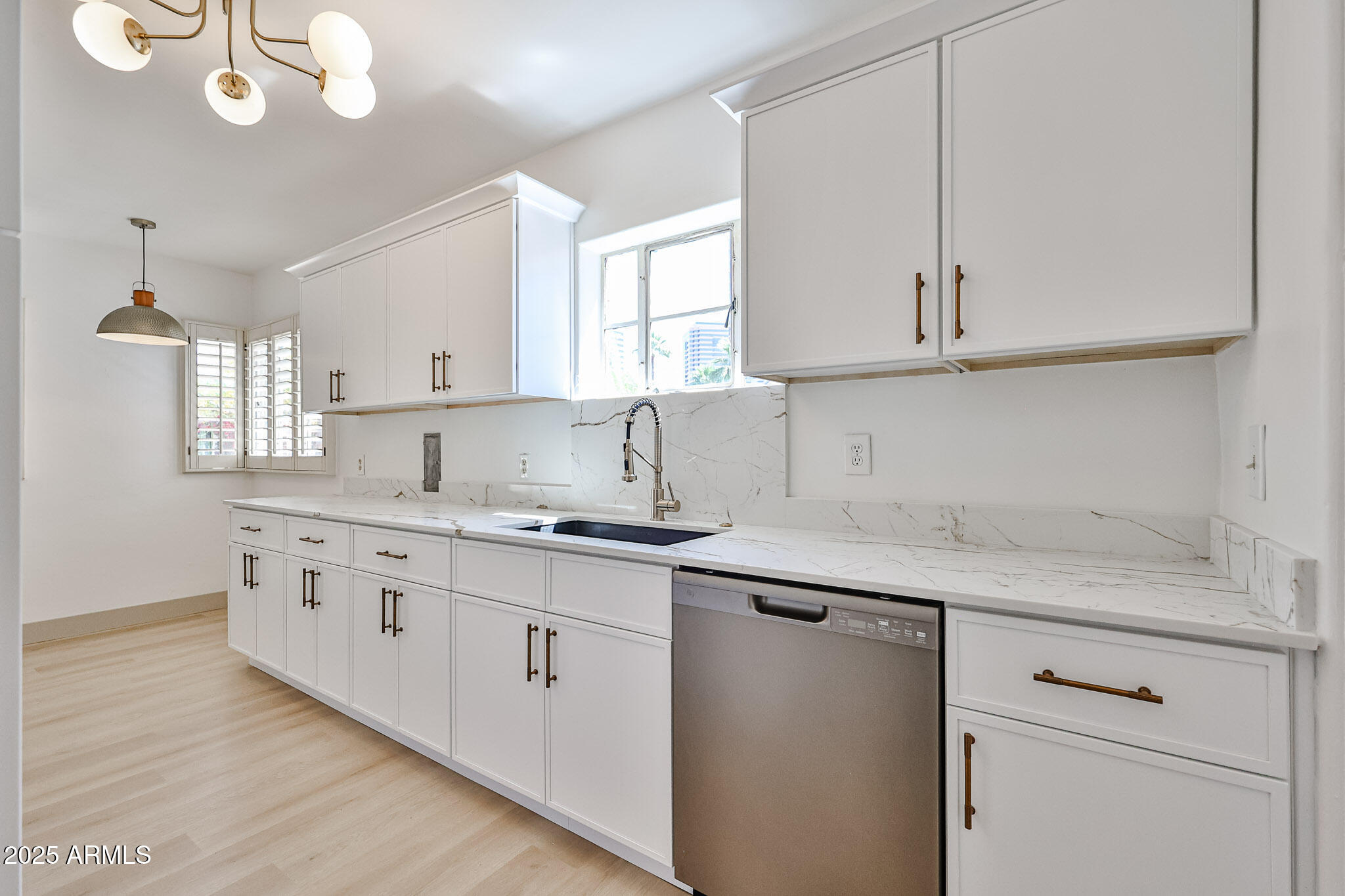63 West Windsor Avenue Phoenix, AZ 85003 - Photo 17 of 43 a kitchen with granite countertop a sink a stove and cabinets