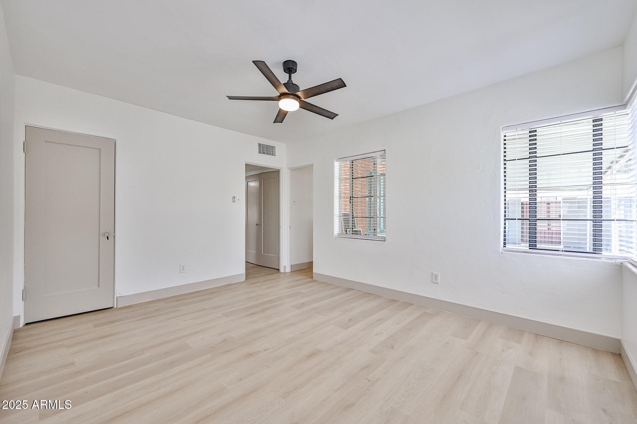 63 West Windsor Avenue Phoenix, AZ 85003 - Photo 21 of 43 a view of empty room with wooden floor and fan