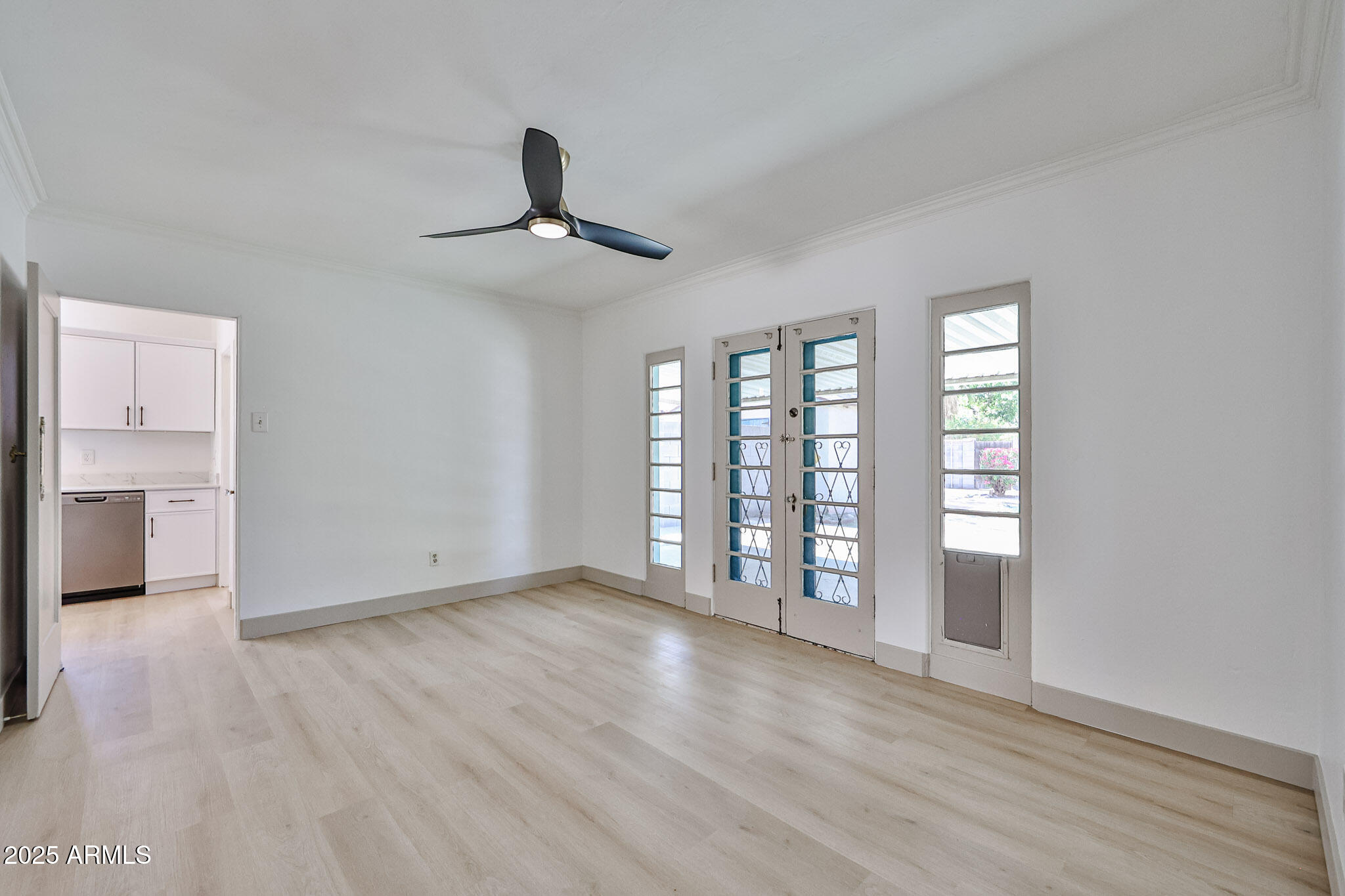 63 West Windsor Avenue Phoenix, AZ 85003 - Photo 9 of 43 a view of an empty room with window and wooden floor