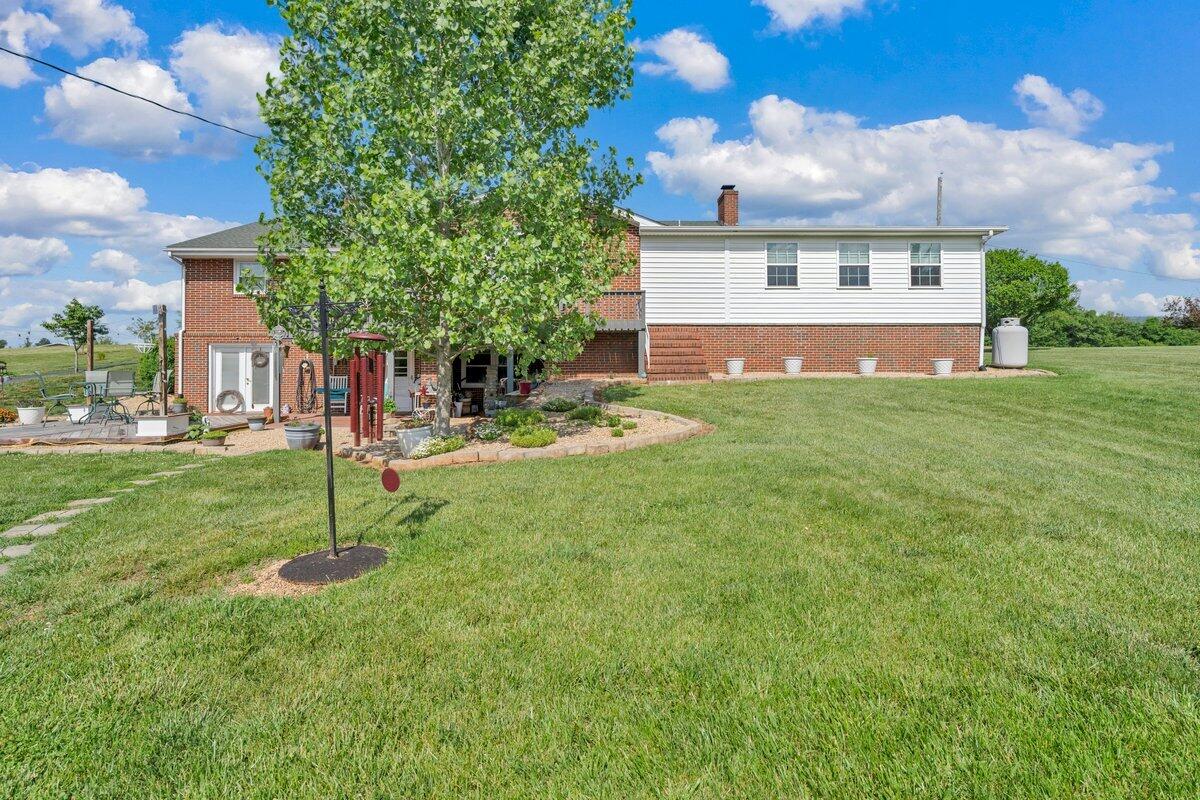 3226 Rakes Road Rocky Mount, VA 24151 - Photo 66 of 74 a view of a house with a yard and a garden