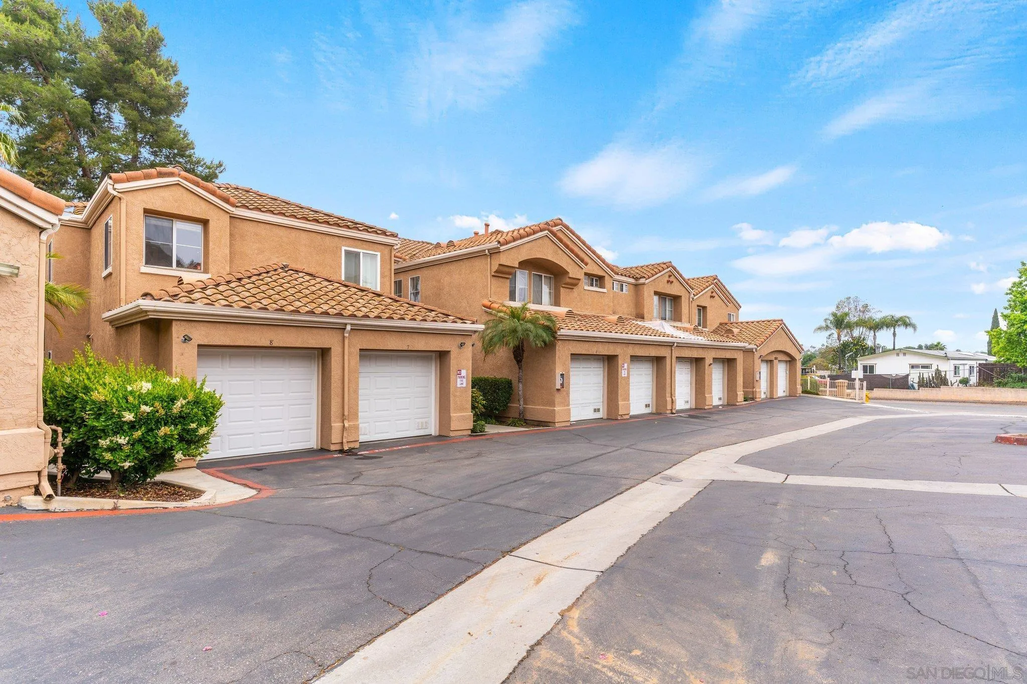 13801 Pinkard Way, Unit 8 El Cajon, CA 92021 - Photo 26 of 29 a front view of a house with a yard and garage