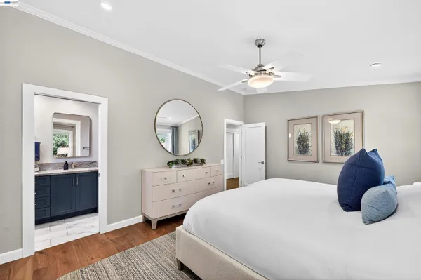 a bedroom with a large bed and a dresser