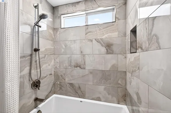 a bathroom with a bathtub and shower