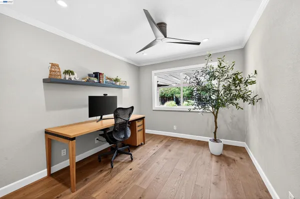 a view of a workspace with furniture and a window