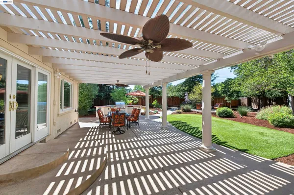 a view of a patio with a table chairs and a backyard