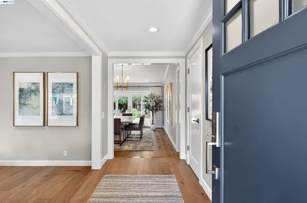 a view of a hallway with wooden floor and windows