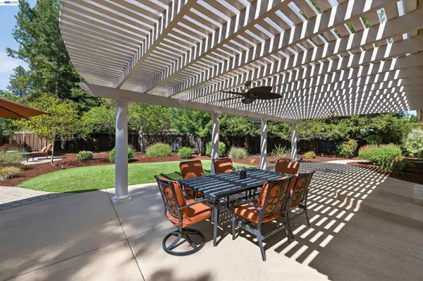 a view of a patio with a table chairs and a backyard
