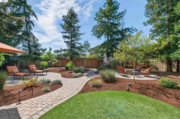 a view of a backyard with sitting area and furniture