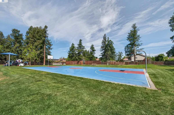 a view of yard with swimming pool and trees