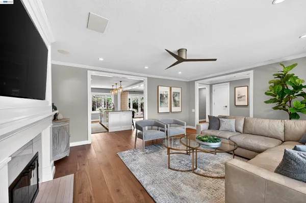 a living room with furniture a fireplace and a flat screen tv