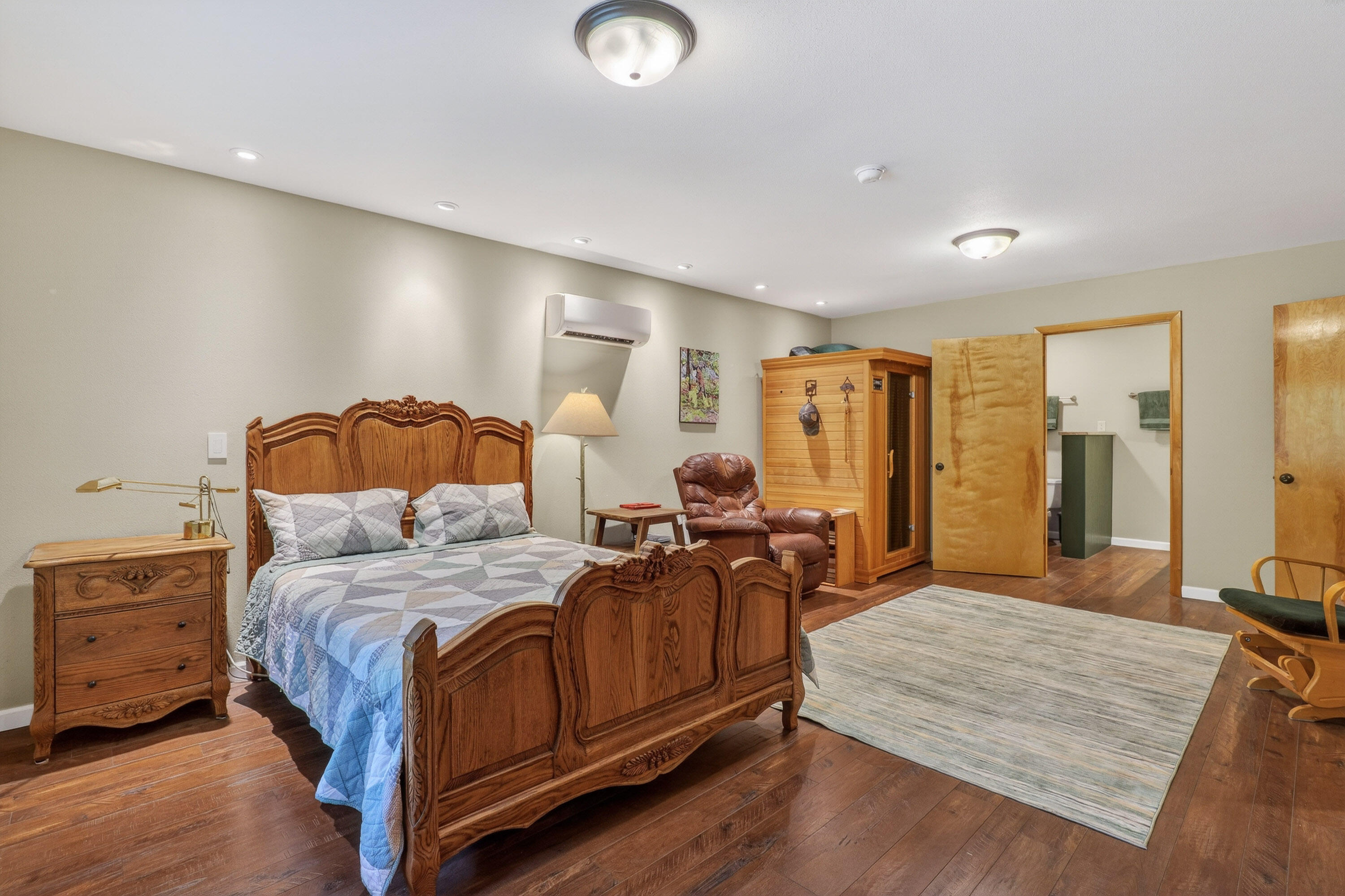 244 Riessen Road Grants Pass, OR 97526 - Photo 16 of 52 a large bedroom with a bed and wooden floor