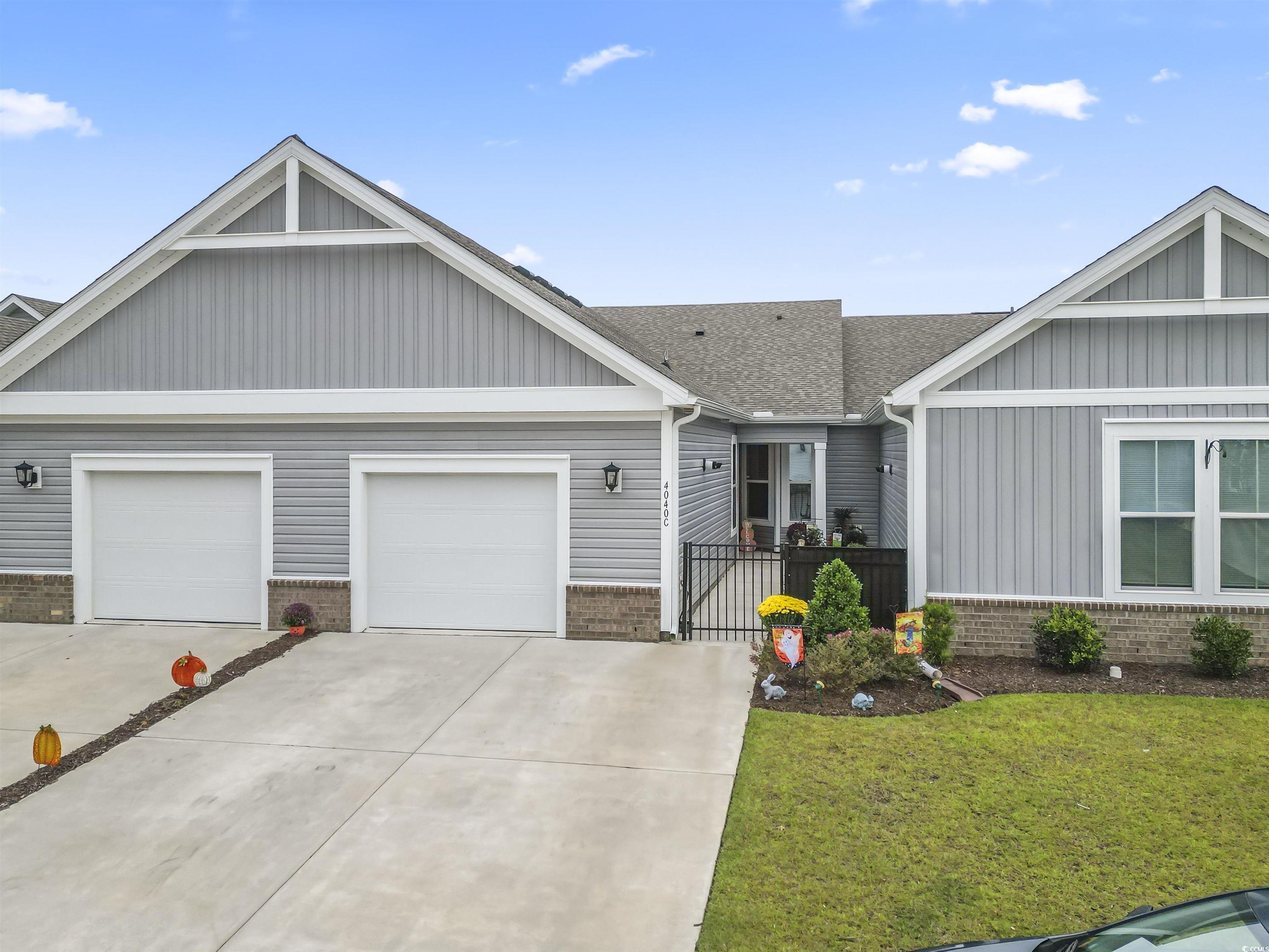 4040 Taranto Loop, Unit 5303C Myrtle Beach, SC 29579 - Photo 1 of 38 View of front of home featuring a shingled roof, brick siding, and concrete driveway