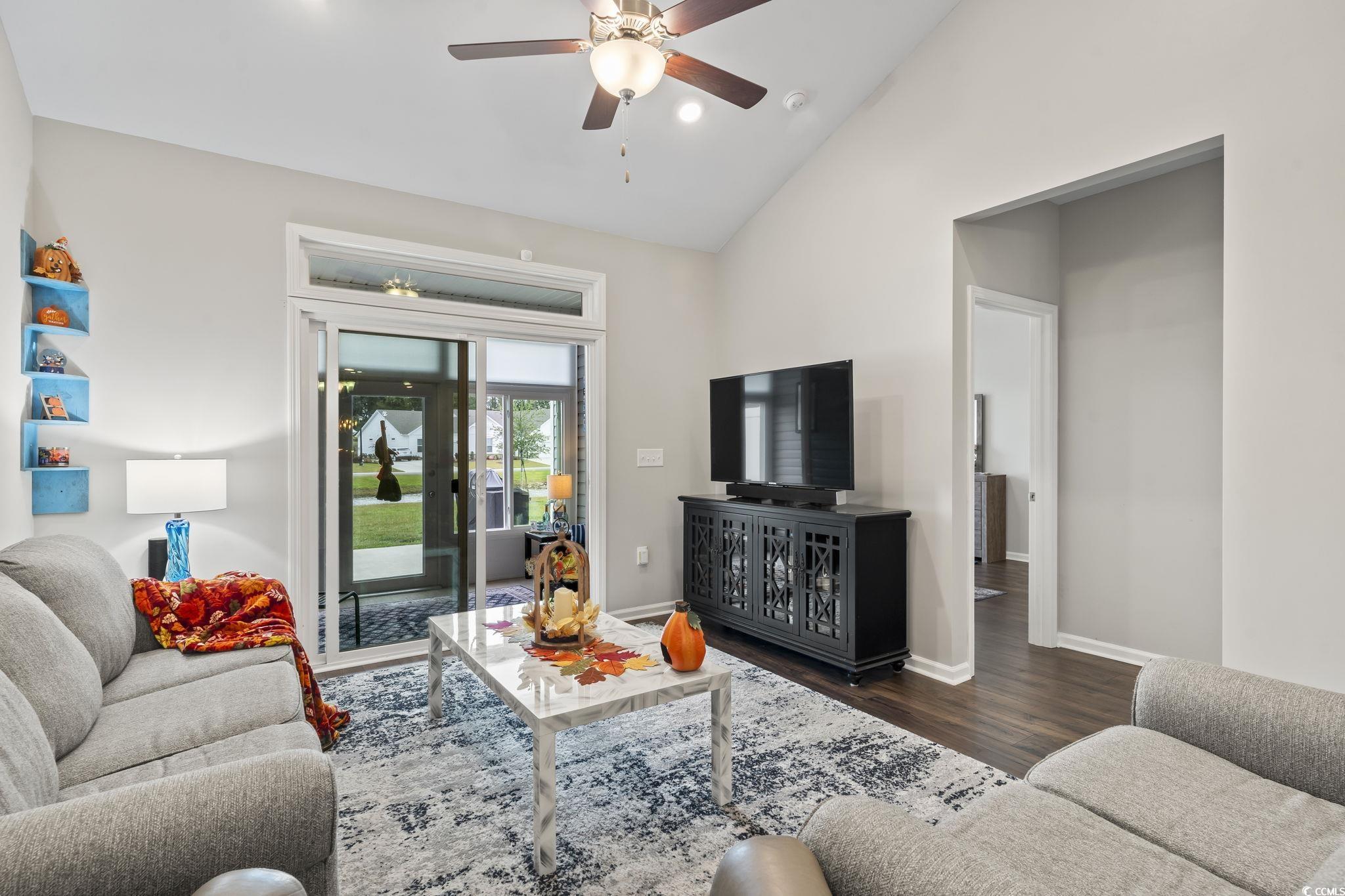 4040 Taranto Loop, Unit 5303C Myrtle Beach, SC 29579 - Photo 15 of 38 Living room featuring vaulted ceiling, dark wood-style floors, and ceiling fan